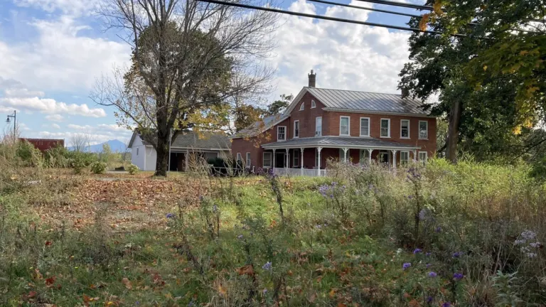 The historic Roswell Butler House in Essex, Vermont, with Camel's Hump in the distance