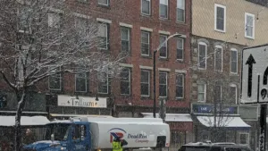 A fuel truck on a snowy Main Street in downtown Brattleboro